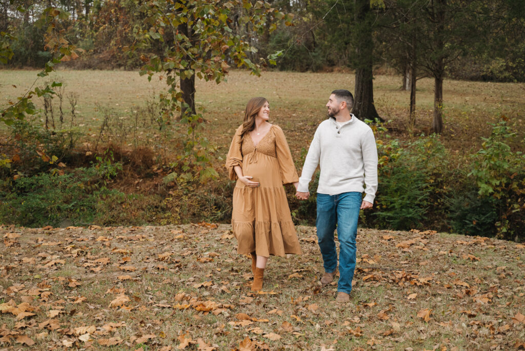 Soon to be parents walking hand in hand 