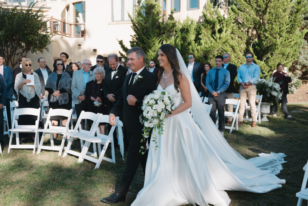 Bride and Father walking down the lawn of Bella Collina 